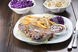 Baked ribs and French fries and cabbage salad