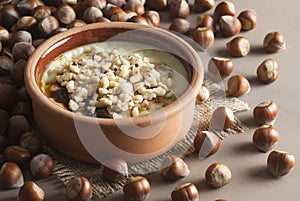 Baked rice pudding turkish milky dessert sutlac in earthenware casserole with hazelnuts