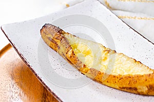 Baked Ripe Plantains with Cheese (Plantain Canoe or Platanos Asados Con Queso) on a plate