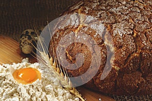 Baked ruddy bread, a row of winter wheat spikes, a hill of flour and quail eggs