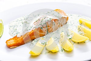 baked salmon with creamy dill sauce and potatoes