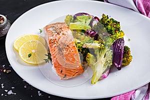 Baked salmon fillet with broccoli, red onion and lemon