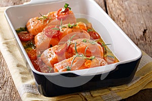 Baked salmon fillet with tomatoes, garlic and rosemary in olive
