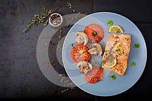 Baked salmon fish fillet with tomatoes