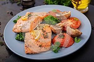 Baked salmon fish fillet with tomatoes, mushrooms and spice