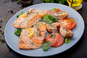 Baked salmon fish fillet with tomatoes, mushrooms and spices