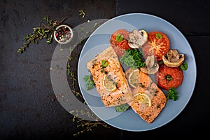 Baked salmon fish fillet with tomatoes, mushrooms and spices.