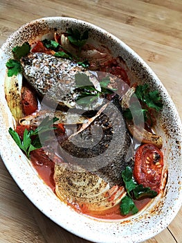 Baked salmon fish fillet with tomatoes and spices. Diet menu. Top view. Flat lay