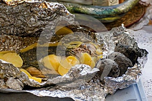 Baked salmon fish in foil. Tasty dish, cooked with potatoes and dill.