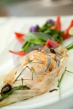 Baked salmon fish in paper foil