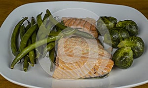 Baked salmon with bussel sprouts and string beans photo