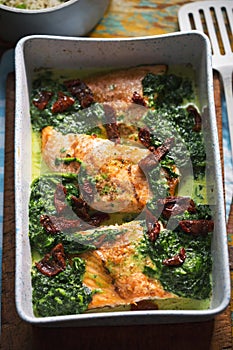 Baked salmon with spinach and sun dried tomatoes