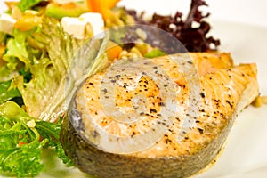 Baked salmon steak and salad