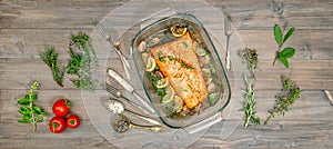 Baked salmon trout fish with fresh herbs and spices