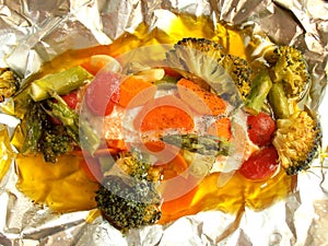 Baked salmon with vegetables in aluminum foil