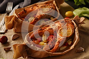 Baked salmon with vegetables on a dark background