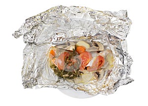 Baked salmon with vegetables and mushrooms in foil.