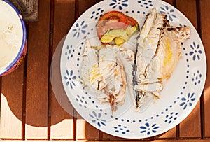 Baked sea bream with tomato and avocado