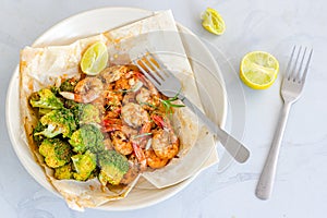 Baked Shrimp and Broccoli in a Packet with Lemon Top View, Flat Lay Food Stock Photo