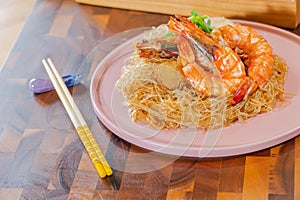 Baked Shrimp with Glass Noodles, a traditional Thai food wrapped in heat-treated freud paper and chopsticks, ready to serve-eat