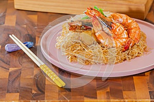 Baked Shrimp with Glass Noodles, a traditional Thai food wrapped in heat-treated freud paper and chopsticks, ready to serve-eat