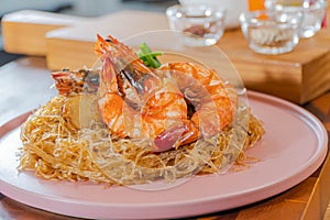 Baked Shrimp with Glass Noodles, a traditional Thai food wrapped in heat-treated freud paper and chopsticks, ready to serve-eat