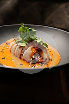 Baked squid stuffed with vegetables and sauce. Stuffed calamari
