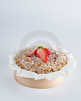 Baked strawberry mini crumble cake on recycle Mini Wooden Baking Mold, white background, copy space, selective focus. Homemade