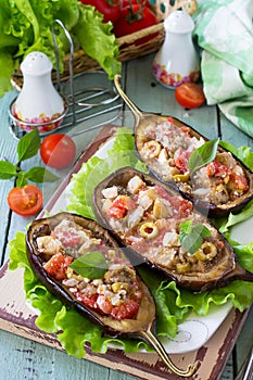 Baked Stuffed Eggplant with Olives, Feta Cheese and Vegetables on a Rustic Table