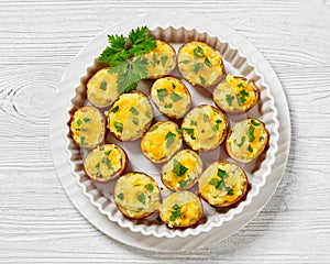 baked stuffed red potato on white baking dish