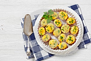 baked stuffed red potato on white baking dish