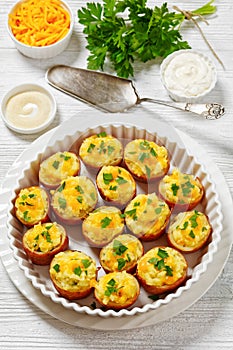 baked stuffed red potato on white baking dish