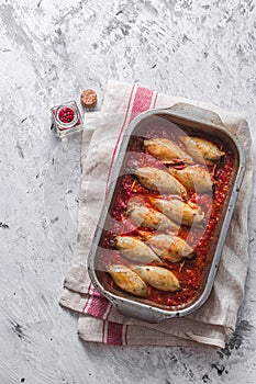 Baked stuffed squid with tomato sauce, copy space