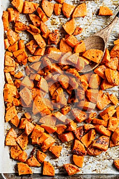 Baked sweet potato on  baking sheet. Vegan food concept