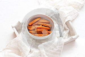 Baked sweet potato in a bowl on a white tray