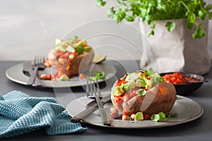 Baked sweet potatoes with avocado chili salsa and beans