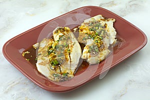 Baked tilapia fish fillets with pesto