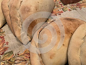 Baked toasted empanadas on autumn design napkins