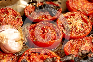 Baked tomatoes with garlic and spices for sauce. Appetizing photo. Macro