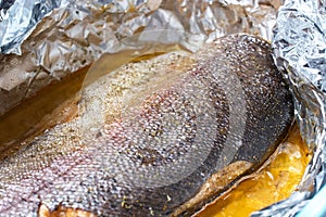 Baked trout in foil in a glass container. vacation concept, birthdays. close-up