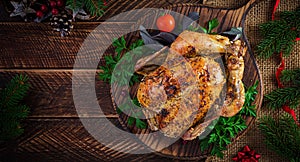 Baked turkey or chicken. The Christmas table is served with a turkey, decorated with bright tinsel.