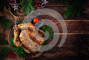 Baked turkey or chicken. The Christmas table is served with a turkey, decorated with bright tinsel.