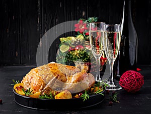 Baked turkey or chicken. The Christmas table is served with a turkey, decorated with bright tinsel. Fried chicken, table setting.