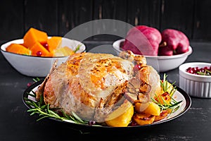 Baked turkey or chicken. The Christmas table is served with a turkey, decorated with bright tinsel. Fried chicken, table setting.