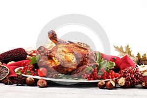 Baked turkey or chicken. The Christmas table is served with a turkey, decorated with fruits, salad and nuts. Fried chicken, table