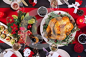 Baked turkey. Christmas dinner. The Christmas table is served with a turkey, decorated with bright tinsel and candles. Fried