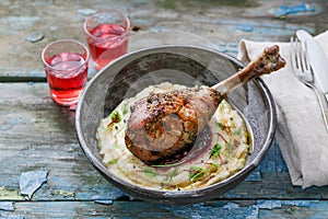 Baked turkey leg with cranberry sauce on mashed celery root, rustic style