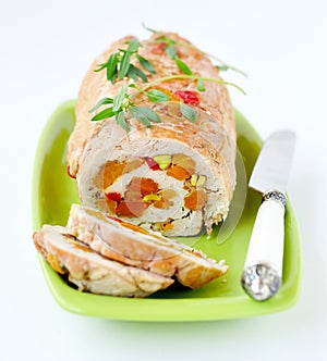 Baked turkey roll stuffed with dried apricots, cherries and pistachios