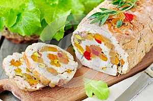 Baked turkey roll stuffed with dried apricots, cherries and pistachios