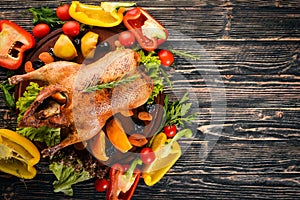 Baked turkey with vegetables and spices. l. On a wooden background. Top view